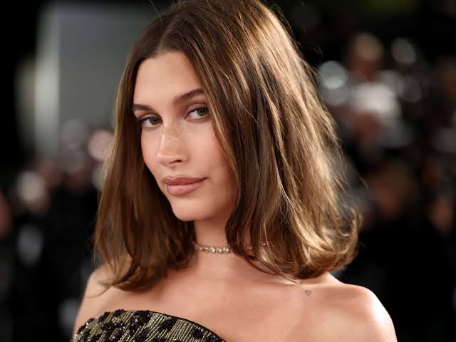 Hailey Bieber's Vintage Mini Slip Dress Has a Faux Optical Illusion Peekaboo Bra Detail at Coachella