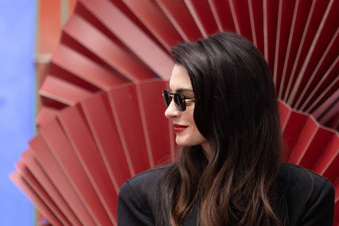 Anne Hathaway Wows in Asymmetrical LBD Dripping in Fringe With a Hip-High Slit and Giant Gilded Accessory